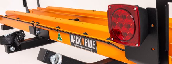 Double electric bike rack hitch carrier closeup of LED tail light kit and distinctive orange wheel trays